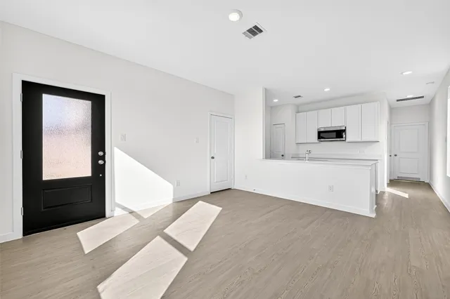 a view of a kitchen with microwave and cabinets