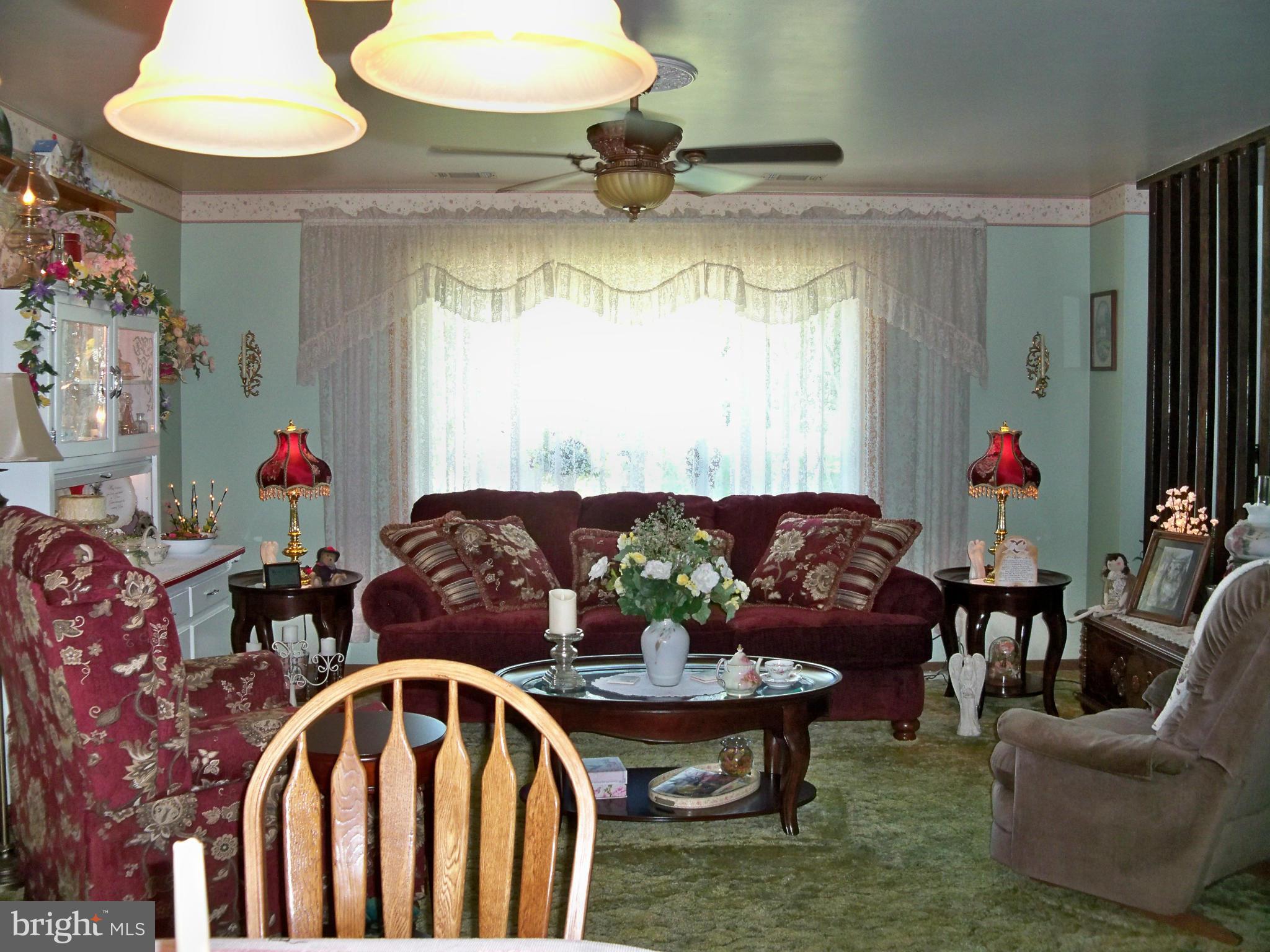 160 Almost Heaven Road Falling Waters, WV 25419 - Photo 13 of 30 a living room with furniture and a chandelier