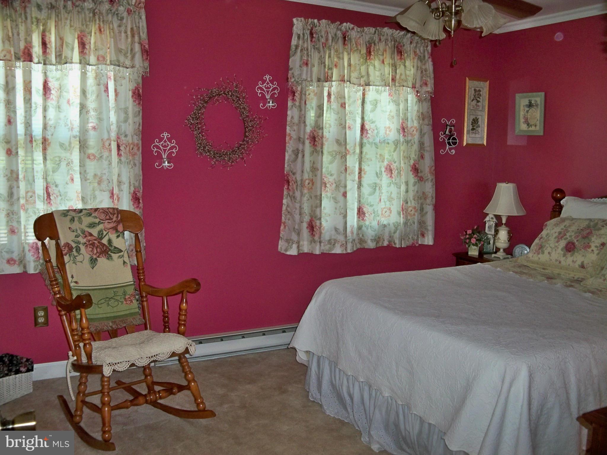 160 Almost Heaven Road Falling Waters, WV 25419 - Photo 14 of 30 a bedroom with a bed chair and window