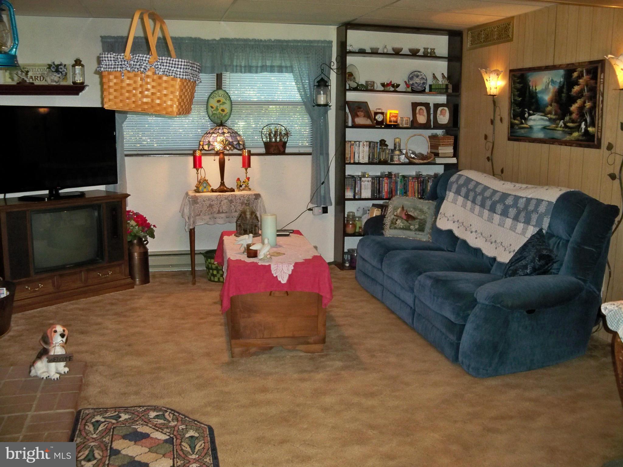 160 Almost Heaven Road Falling Waters, WV 25419 - Photo 21 of 30 a living room with furniture and a flat screen tv