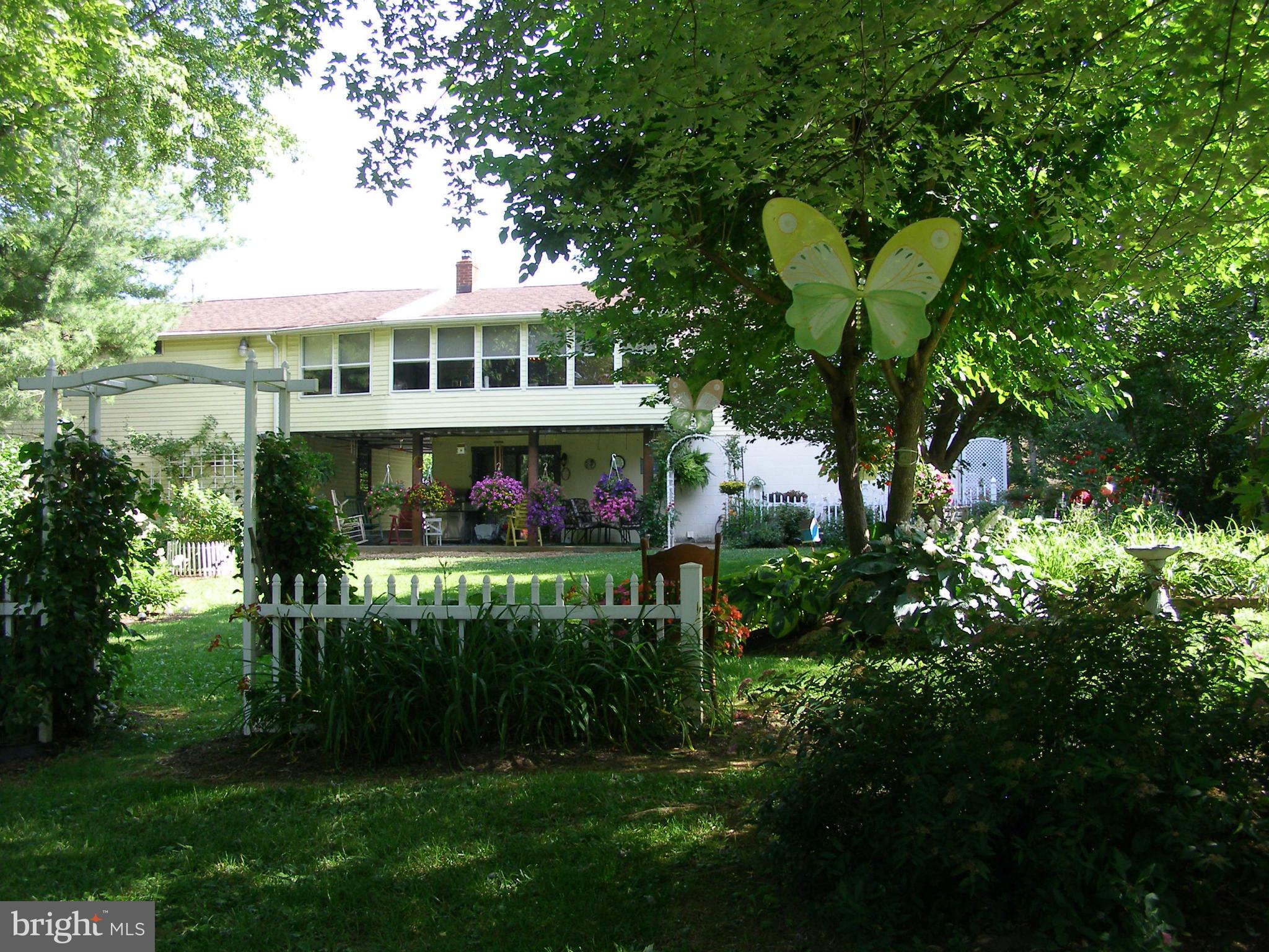 160 Almost Heaven Road Falling Waters, WV 25419 - Photo 4 of 30 a front view of a house with a garden and plants