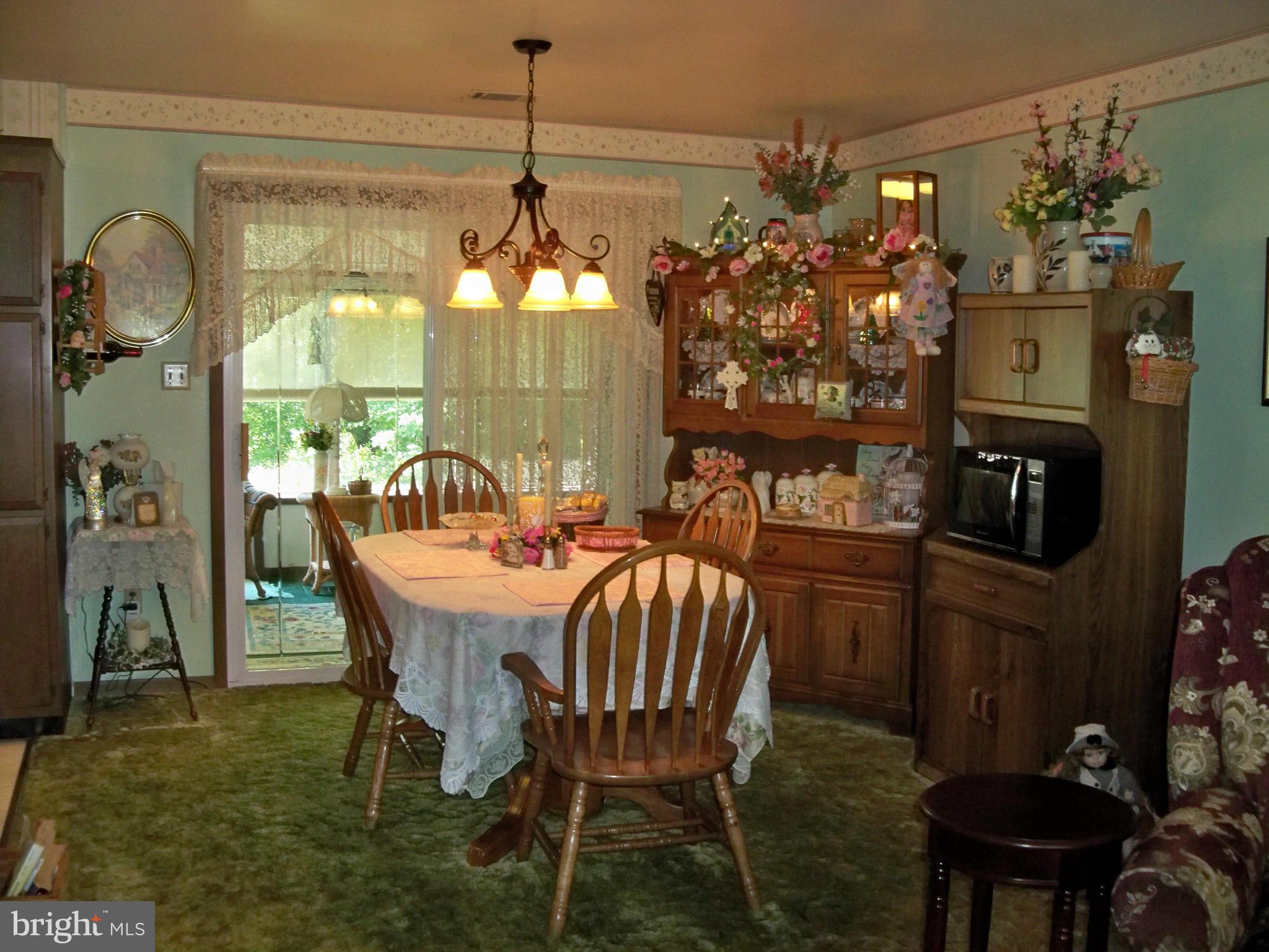 160 Almost Heaven Road Falling Waters, WV 25419 - Photo 8 of 30 a dining room with furniture a chandelier and window