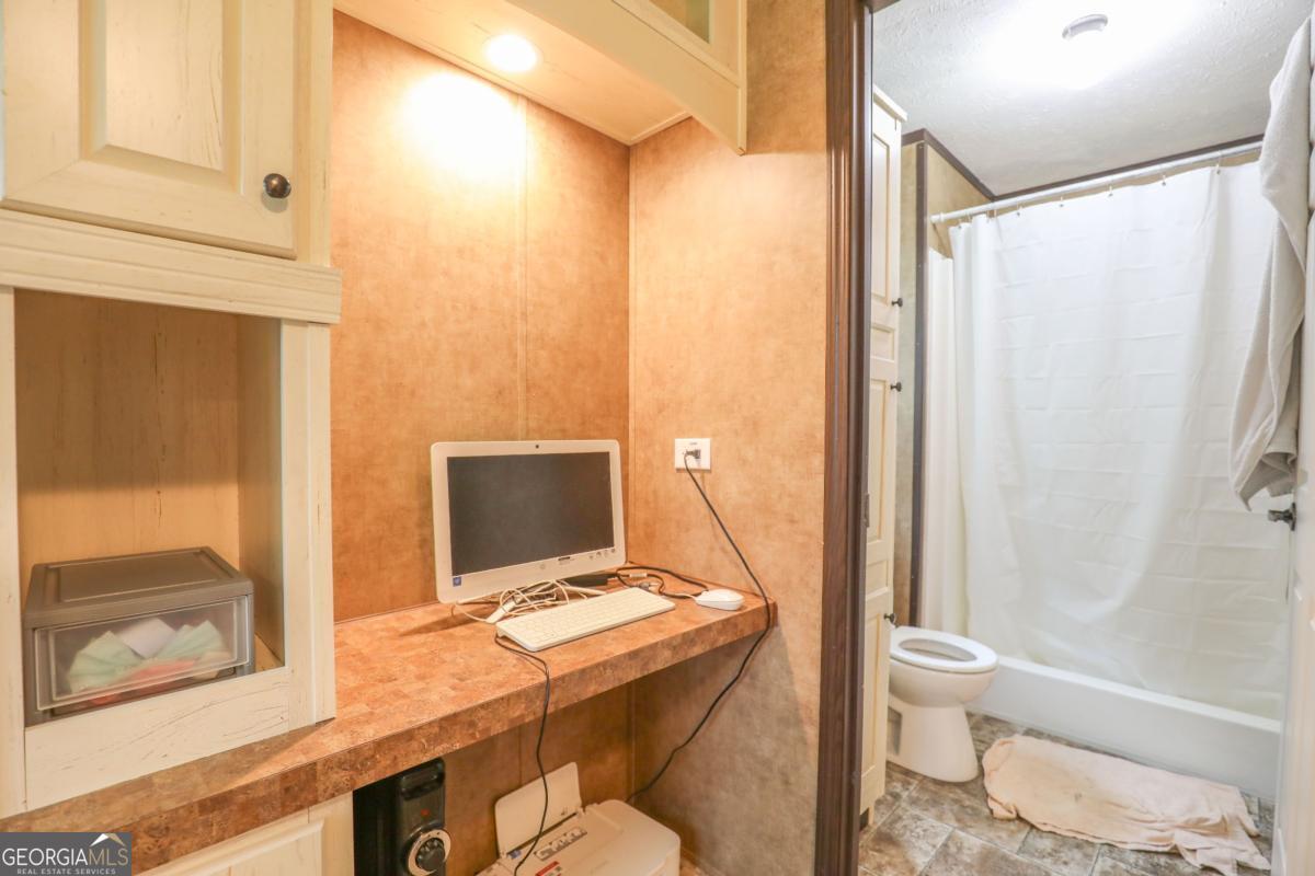 143 Mccullar Weaver Road Southwest Milledgeville, GA 31061 - Photo 15 of 28 a bathroom with a sink and a mirror