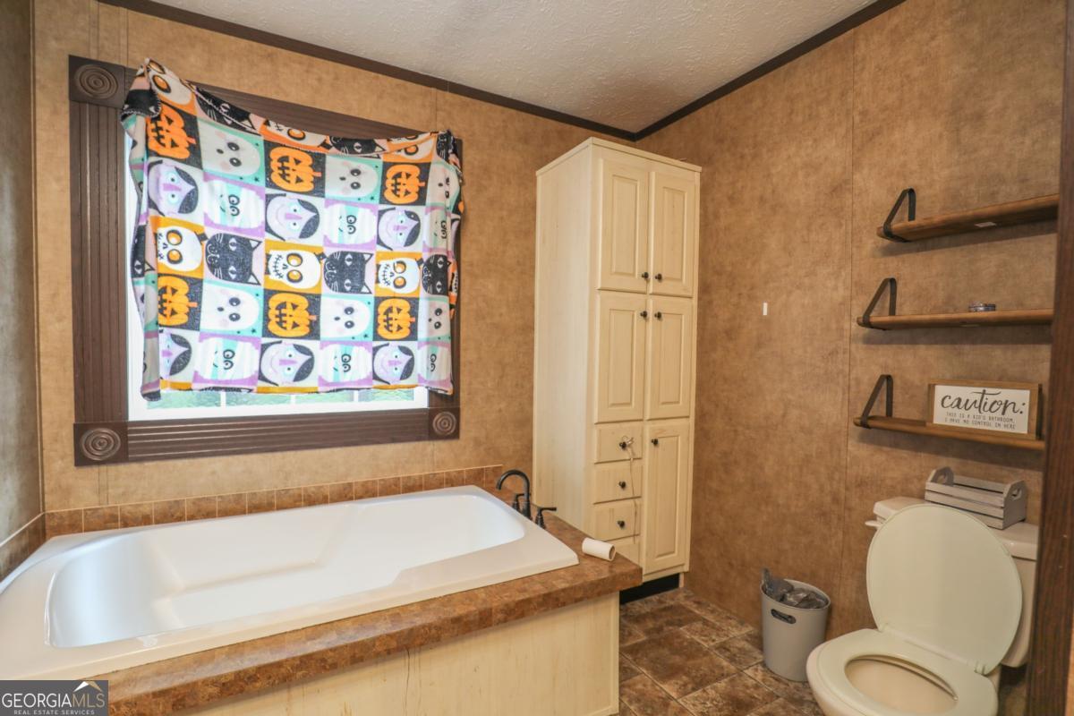 143 Mccullar Weaver Road Southwest Milledgeville, GA 31061 - Photo 19 of 28 a bathroom with a sink and toilet