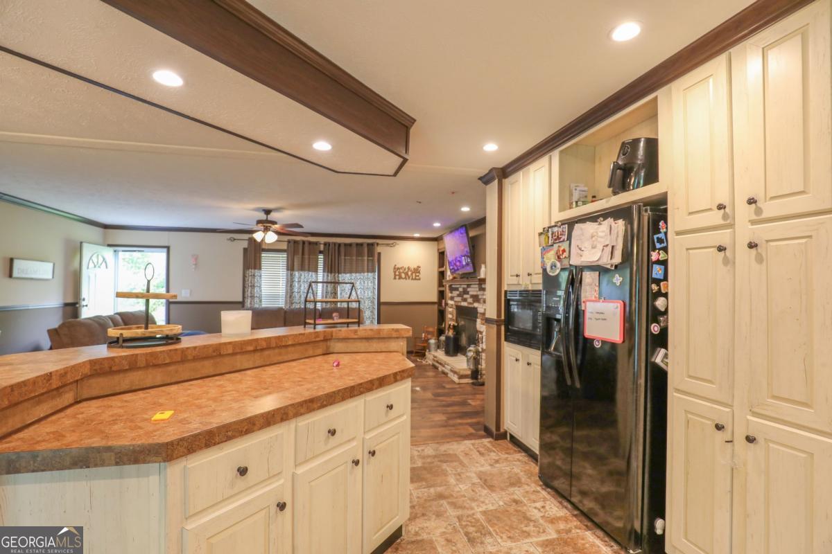 143 Mccullar Weaver Road Southwest Milledgeville, GA 31061 - Photo 7 of 28 a view of a kitchen center island cabinets and living room