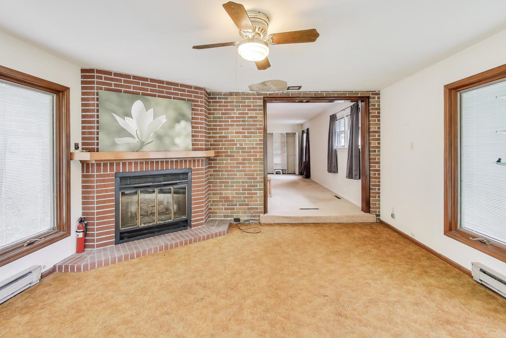 507 North Hamlin Avenue Park Ridge, IL 60068 - Photo 12 of 30 an empty room with fireplace fan and windows