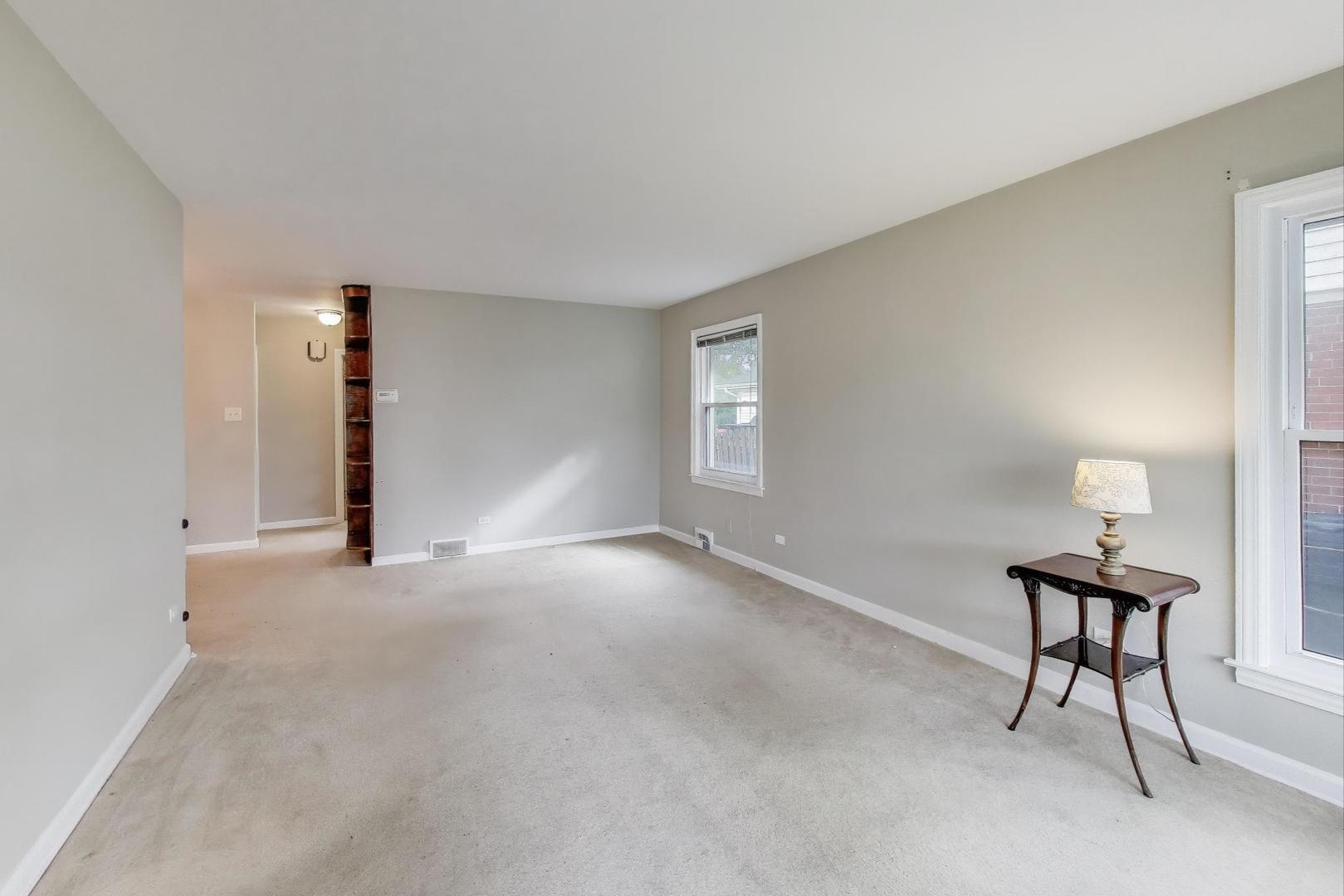 507 North Hamlin Avenue Park Ridge, IL 60068 - Photo 2 of 30 a view of a livingroom with wooden floor and a staircase