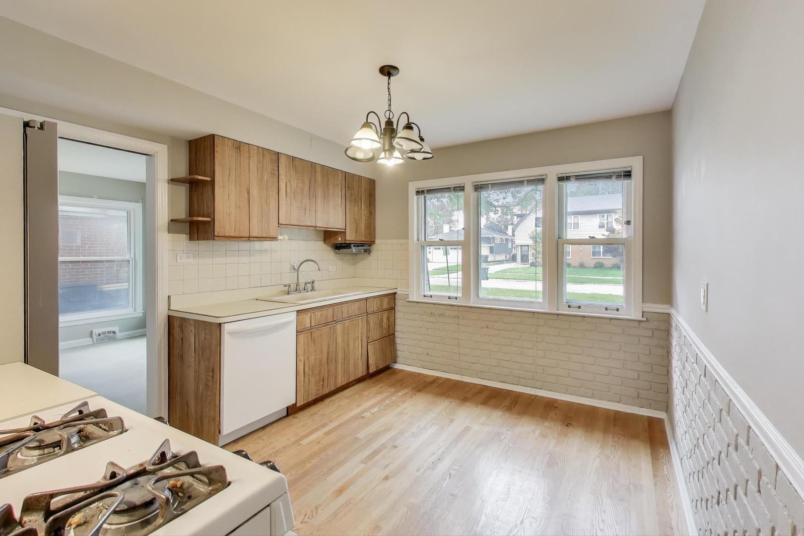 507 North Hamlin Avenue Park Ridge, IL 60068 - Photo 8 of 30 a kitchen with a stove a sink and a refrigerator