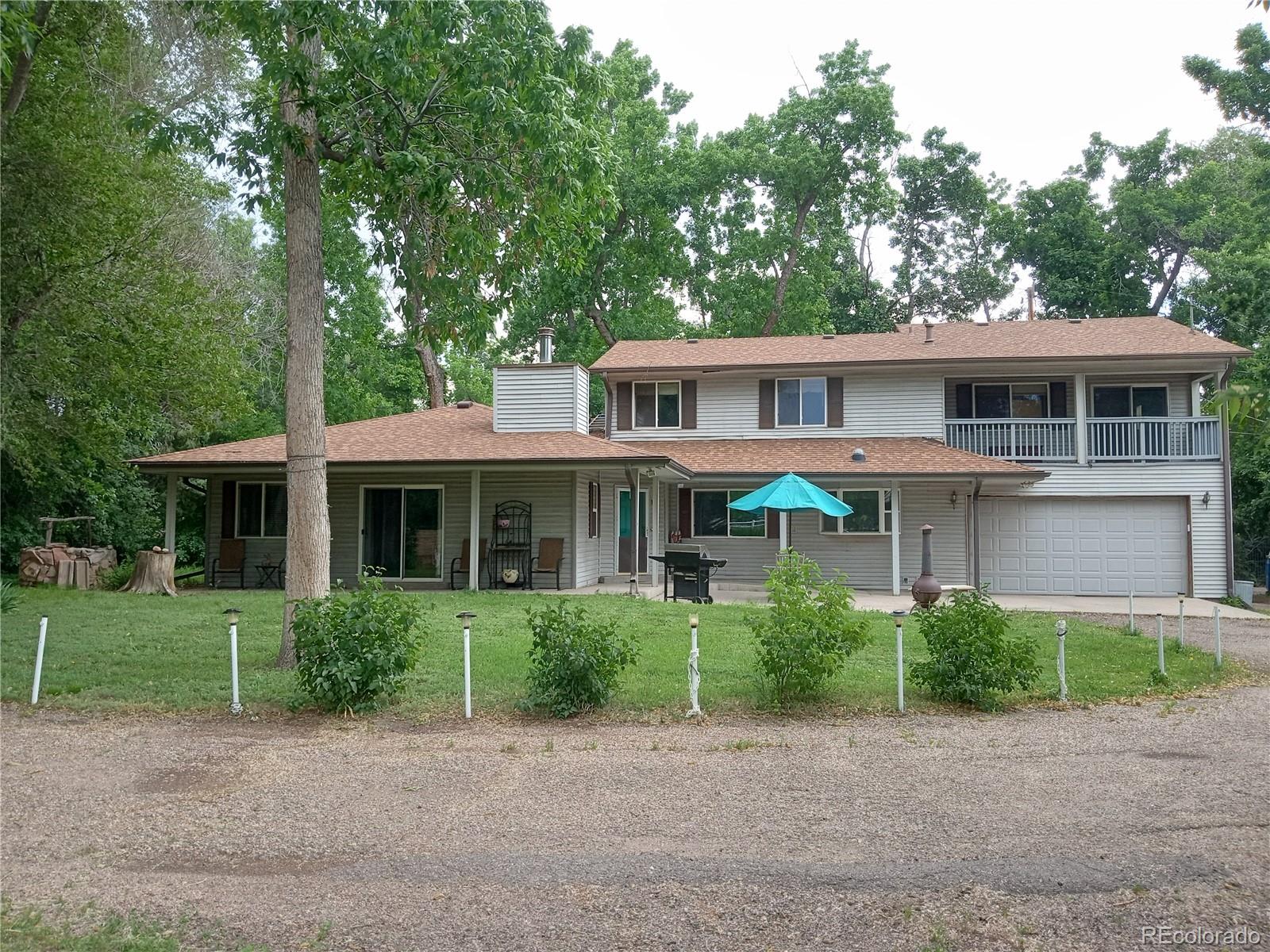 7150 South Platte Canyon Road Littleton, CO 80128 - Photo 1 of 37 a view of a yard in front of house