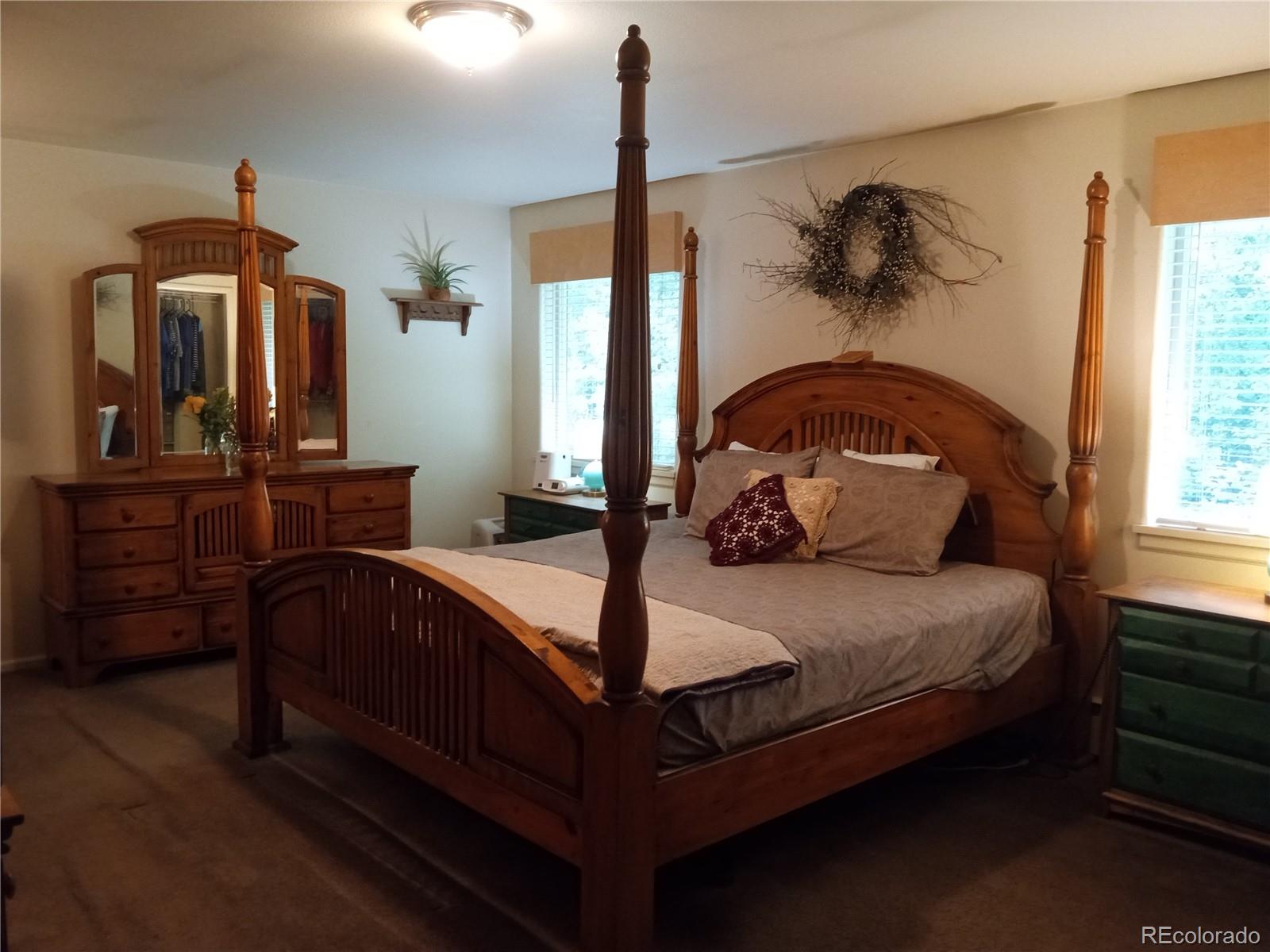 7150 South Platte Canyon Road Littleton, CO 80128 - Photo 11 of 37 a bed sitting in a bedroom next to a window