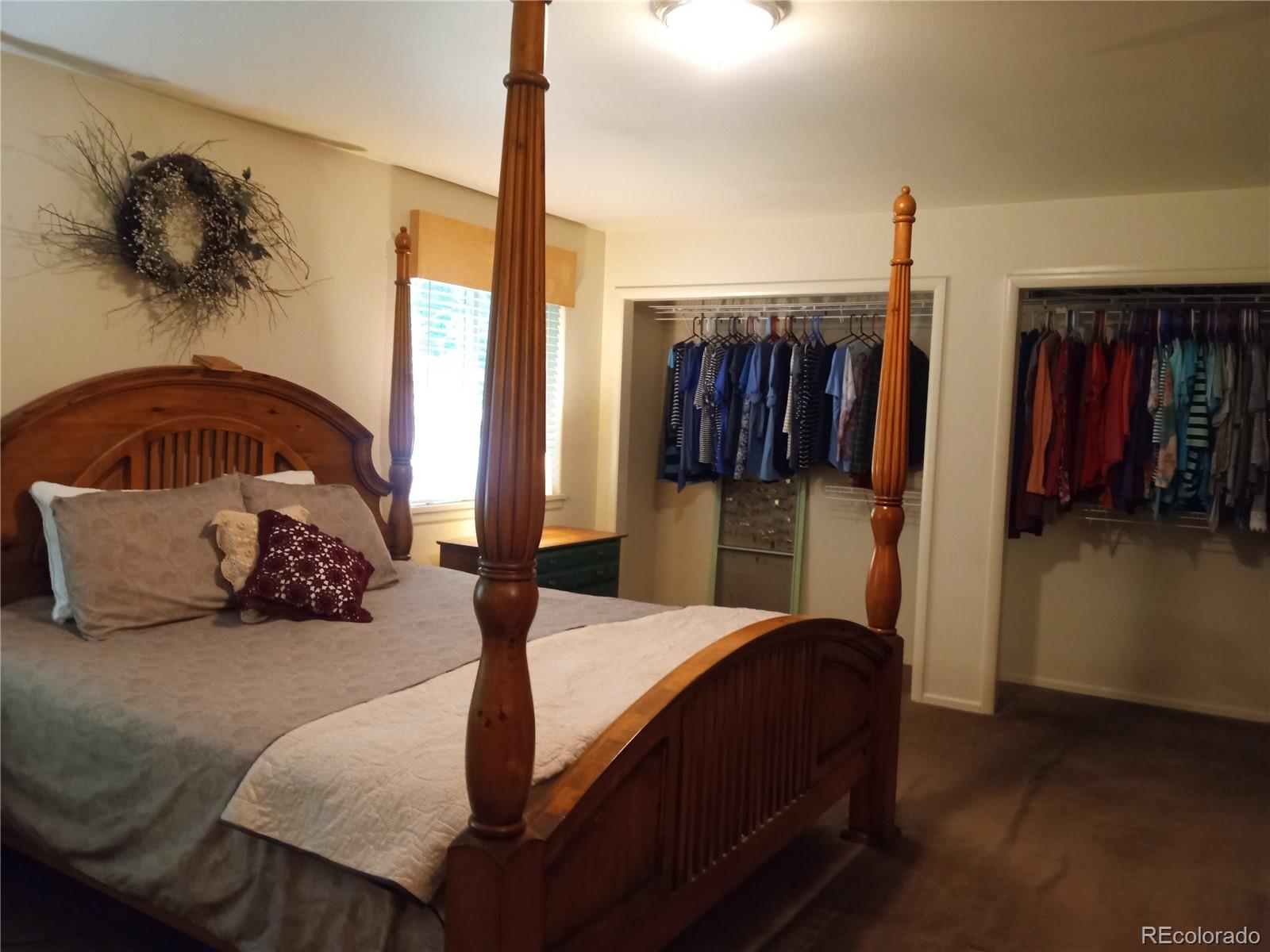 7150 South Platte Canyon Road Littleton, CO 80128 - Photo 12 of 37 a bedroom with a bed and walk in closet