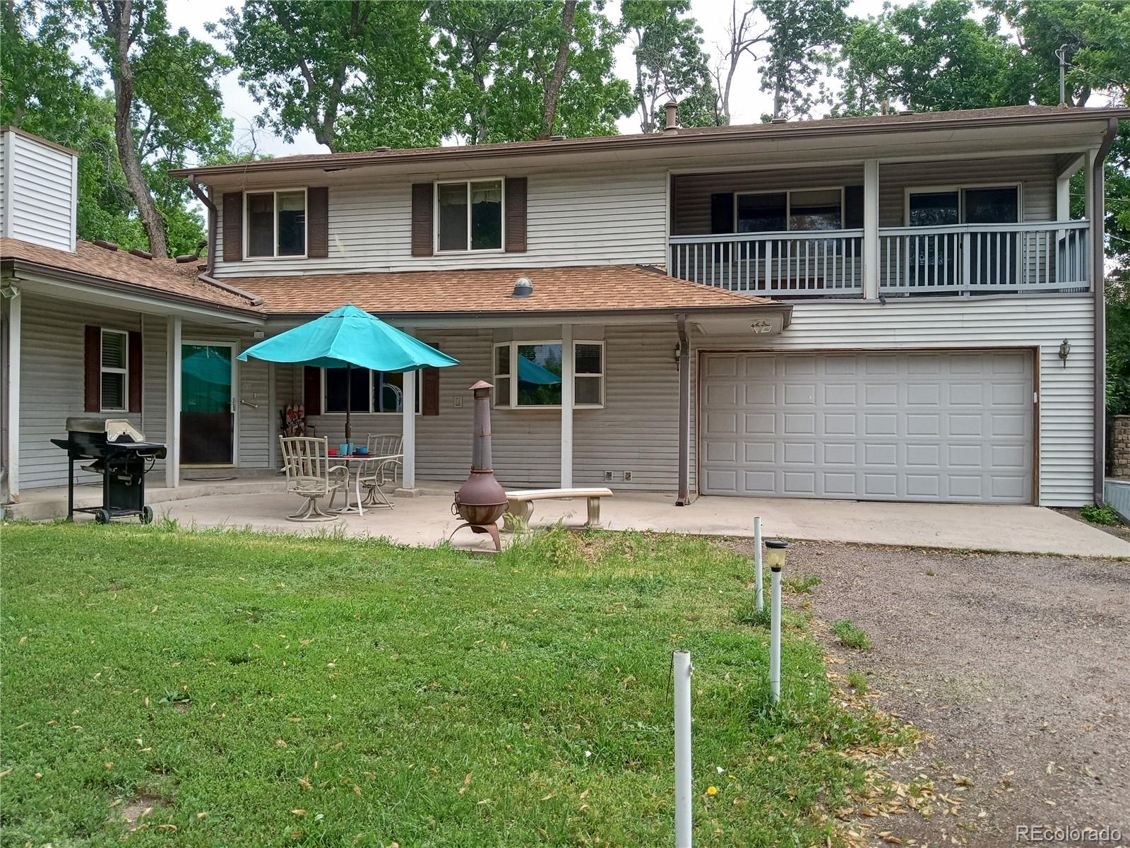 7150 South Platte Canyon Road Littleton, CO 80128 - Photo 2 of 37 a front view of house with yard