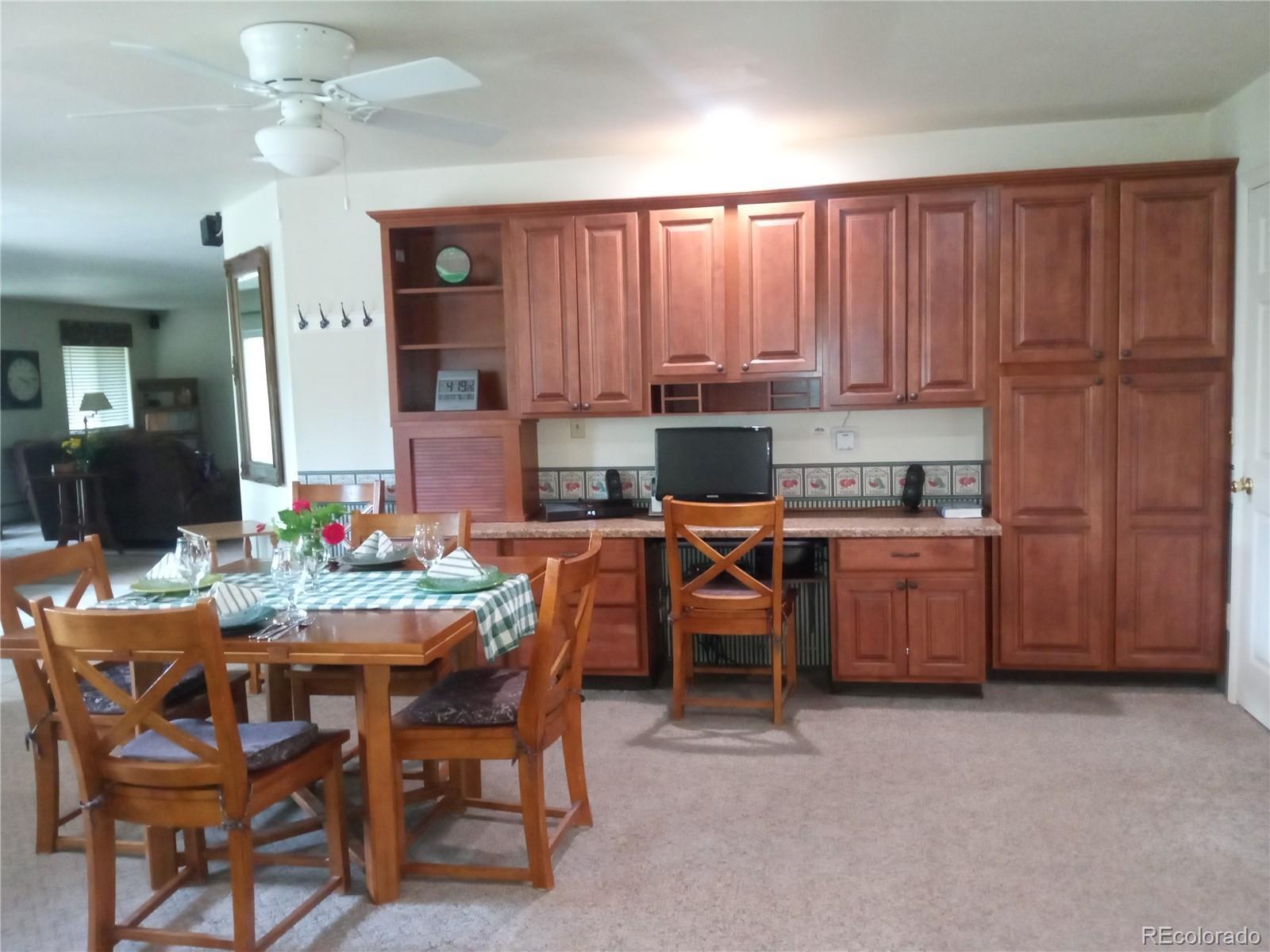 7150 South Platte Canyon Road Littleton, CO 80128 - Photo 22 of 37 a kitchen with a table chairs sink and cabinets