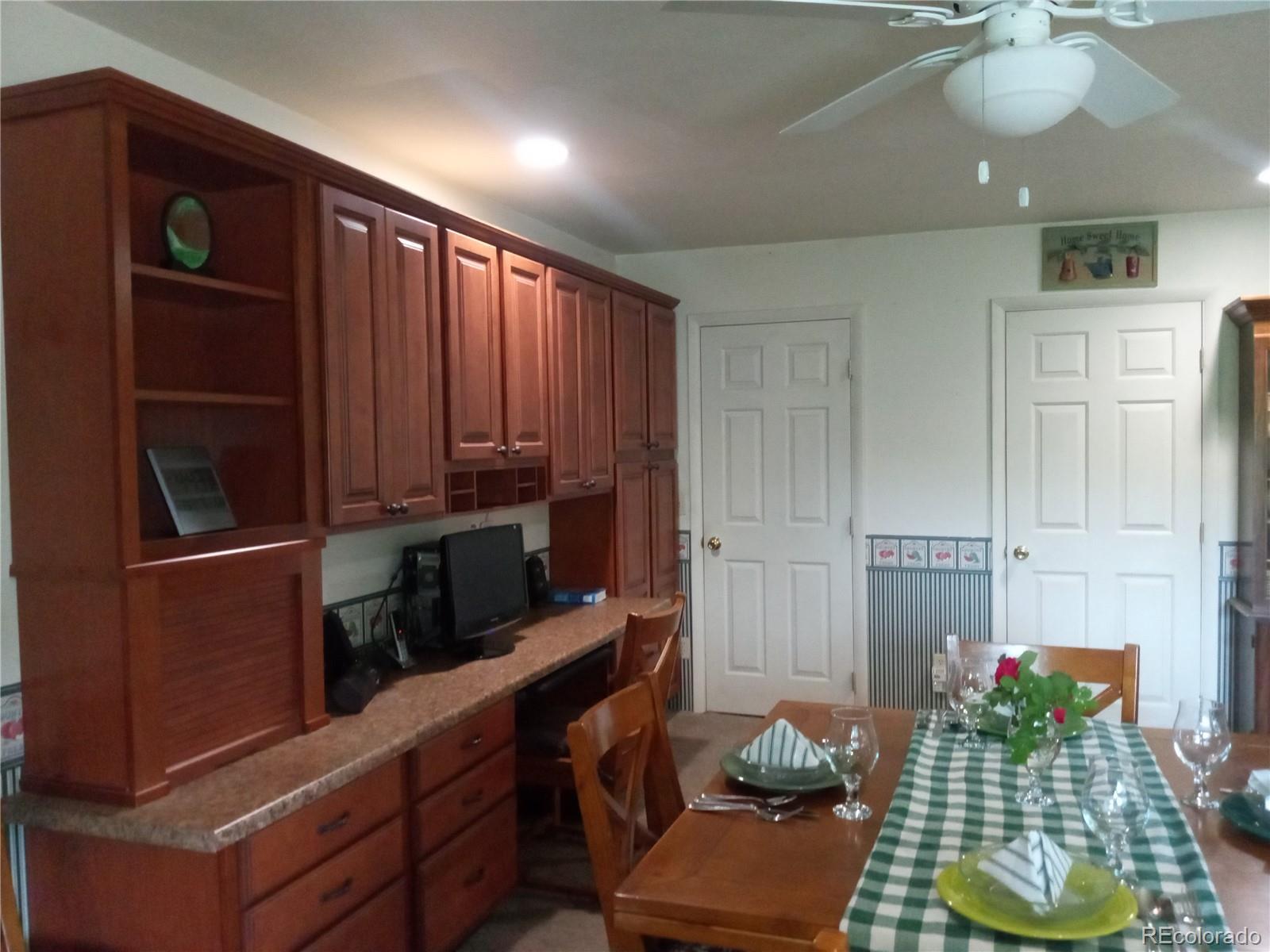 7150 South Platte Canyon Road Littleton, CO 80128 - Photo 23 of 37 a kitchen with sink refrigerator and dining table