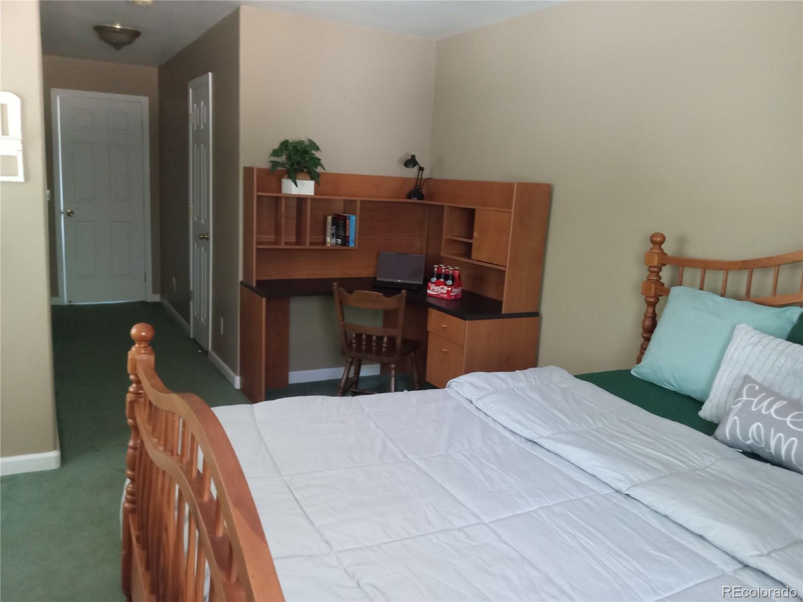 7150 South Platte Canyon Road Littleton, CO 80128 - Photo 32 of 37 a bedroom with a bed and dresser