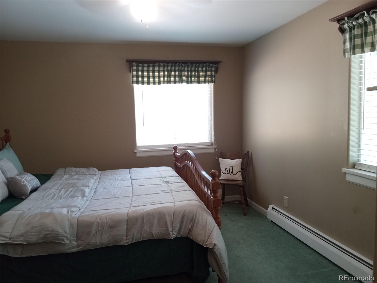7150 South Platte Canyon Road Littleton, CO 80128 - Photo 33 of 37 a bedroom with a bed and a window