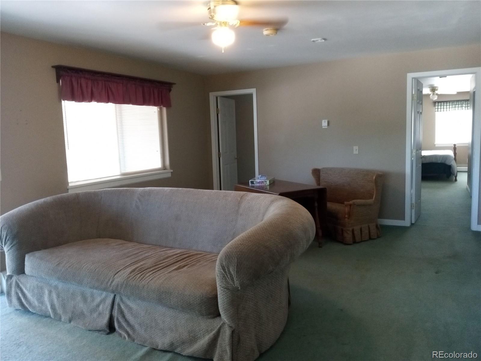 7150 South Platte Canyon Road Littleton, CO 80128 - Photo 35 of 37 a bed sitting in a bedroom next to a window