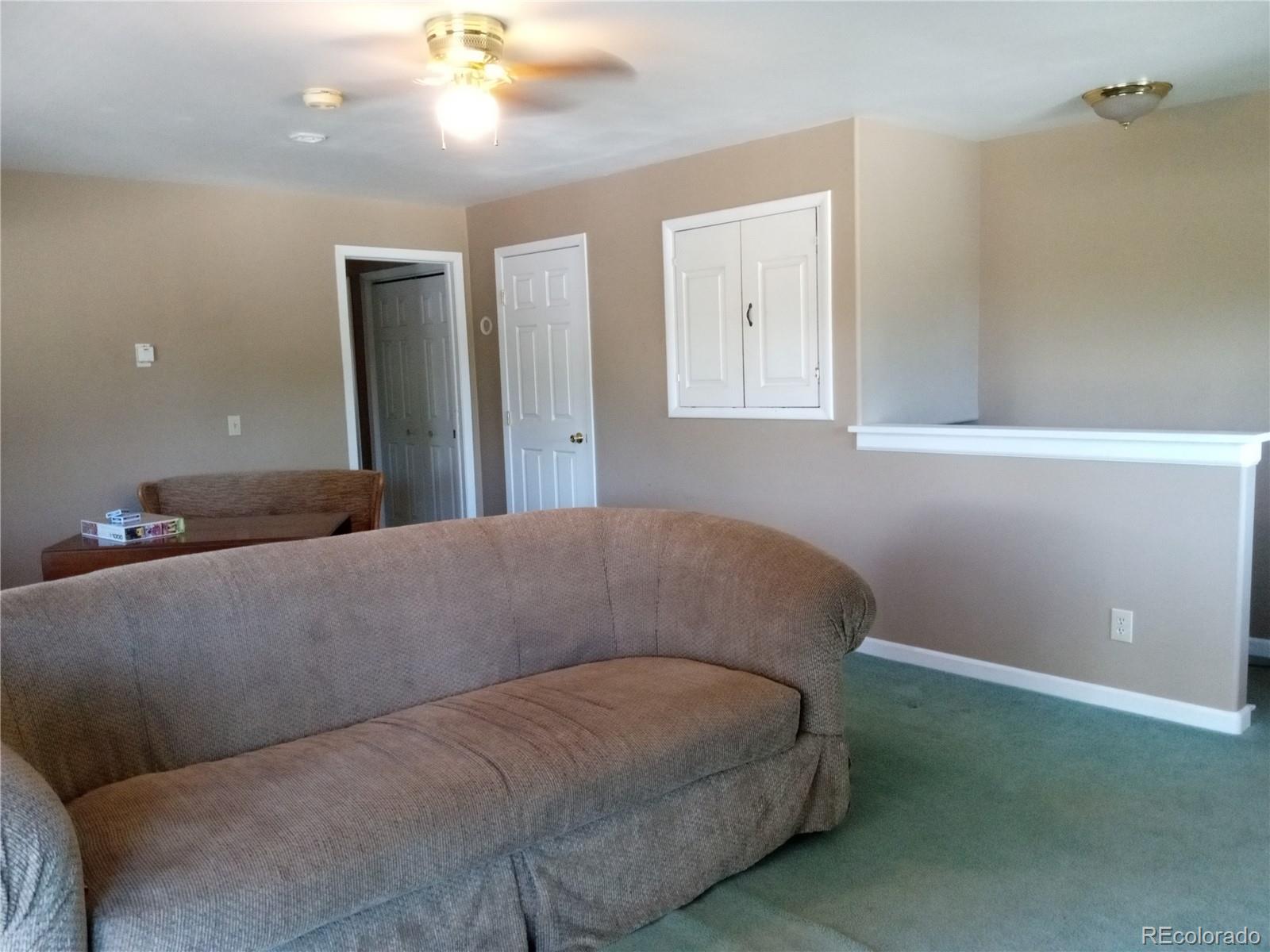 7150 South Platte Canyon Road Littleton, CO 80128 - Photo 36 of 37 a living room with a couch
