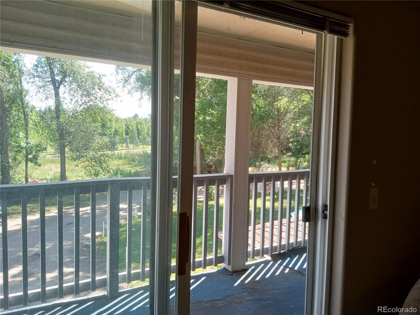 7150 South Platte Canyon Road Littleton, CO 80128 - Photo 37 of 37 a view of a room with wooden floor and a floor to ceiling window