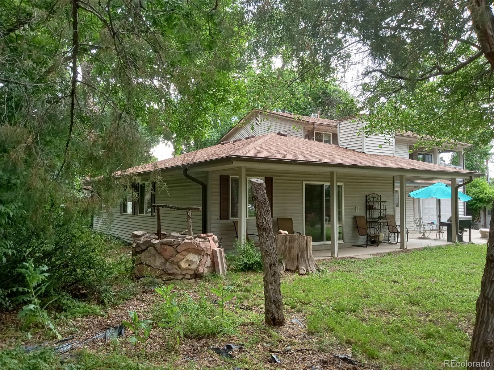 7150 South Platte Canyon Road Littleton, CO 80128 - Photo 5 of 37 a front view of a house with garden