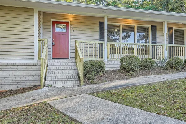 a front view of a house with a garden
