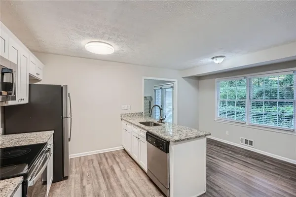 a kitchen with a stove and a refrigerator