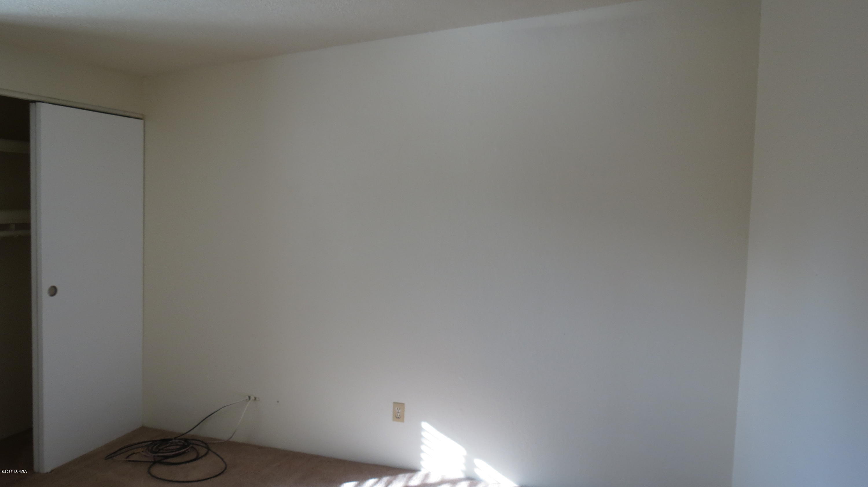 6601 North Mona Lisa Road Tucson, AZ 85741 - Photo 12 of 23 a room with a lamp and a window