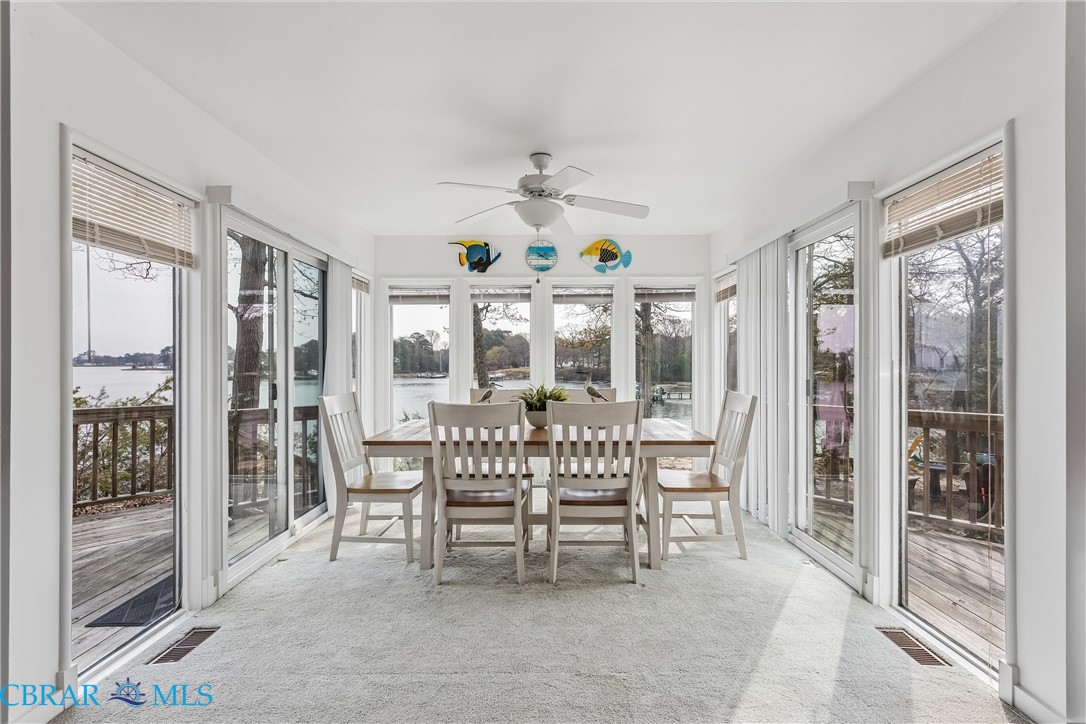 172 Sturgeon Creek Road Deltaville, VA 23043 - Photo 5 of 50 Sunroom featuring carpet floors and a water view