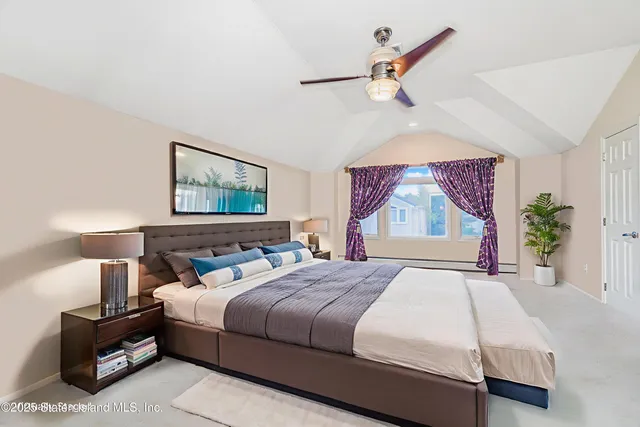 a bedroom with a bed and a painting on the wall