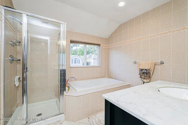 a bathroom with a granite countertop sink a toilet and shower