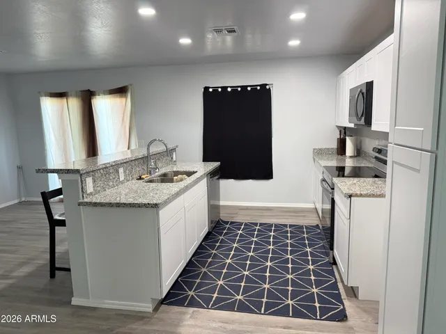 a bathroom with a sink a toilet a mirror and shower