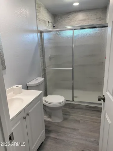 a bathroom with a toilet sink and shower