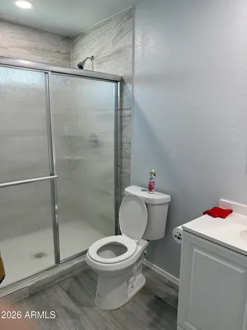 a white toilet sitting next to a shower