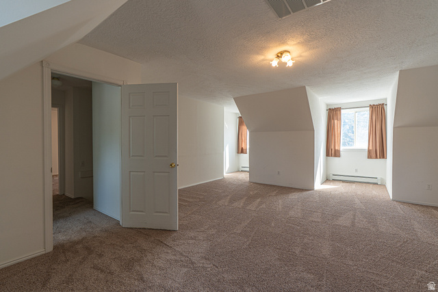 1045 Fox Farm Road Logan, UT 84321 - Photo 51 of 65 Bonus room with a textured ceiling, light colored carpet, and baseboard heating