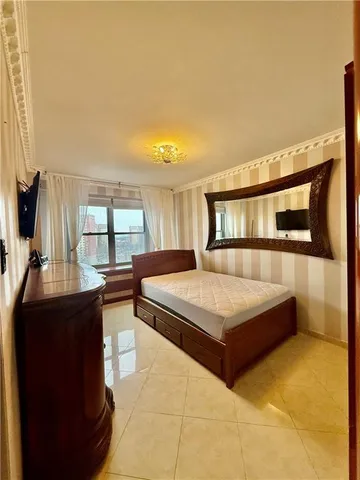 a bedroom with a bed window and dresser