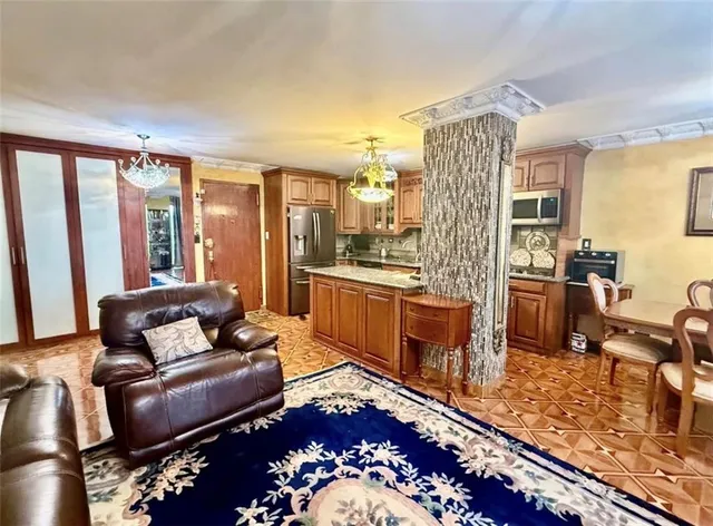 a living room with furniture and a floor to ceiling window