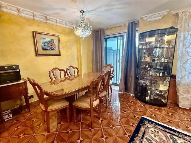 a view of a dining room with furniture and chandelier