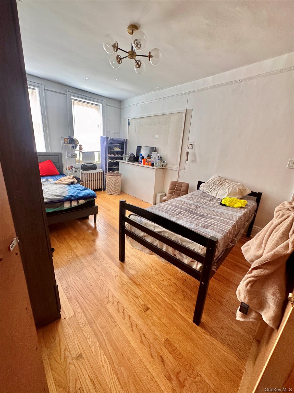 33-54 99th Street Queens, NY 11368 - Photo 15 of 41 a living room with furniture and a wooden floor