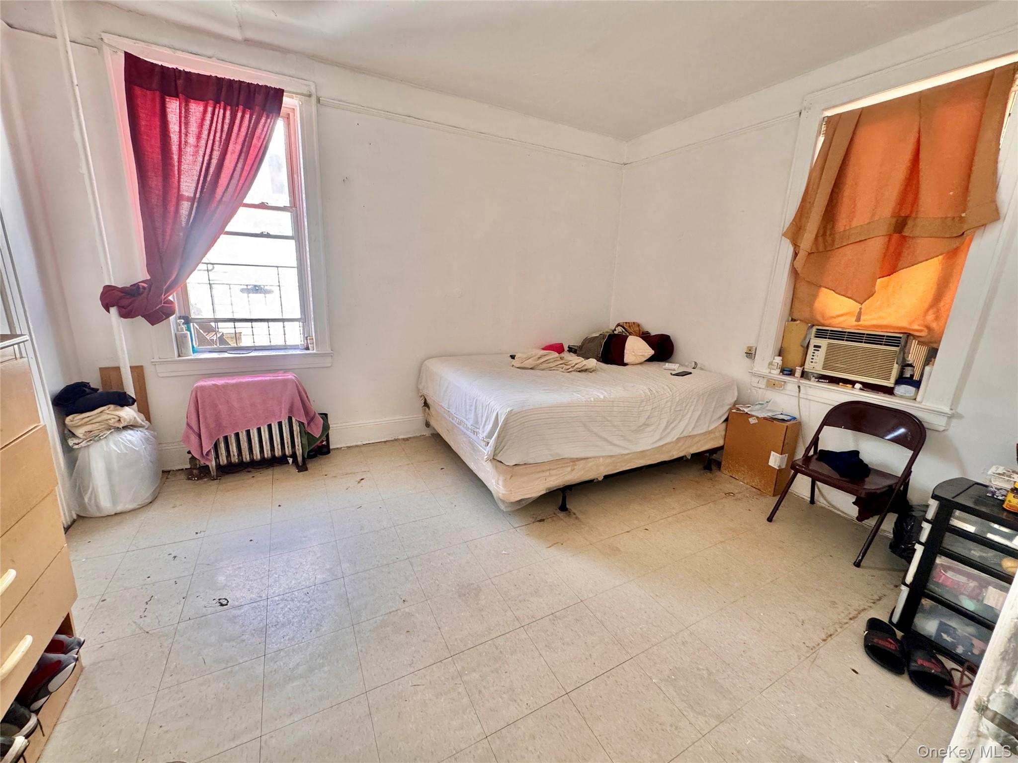 33-54 99th Street Queens, NY 11368 - Photo 18 of 41 a bedroom with bed and window