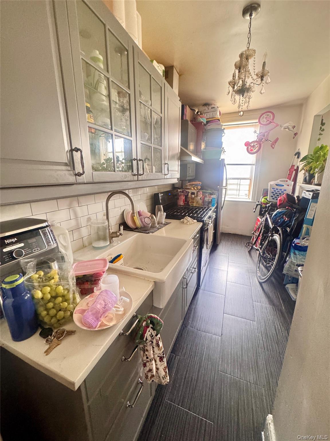 33-54 99th Street Queens, NY 11368 - Photo 33 of 41 a kitchen with a sink stove and cabinets