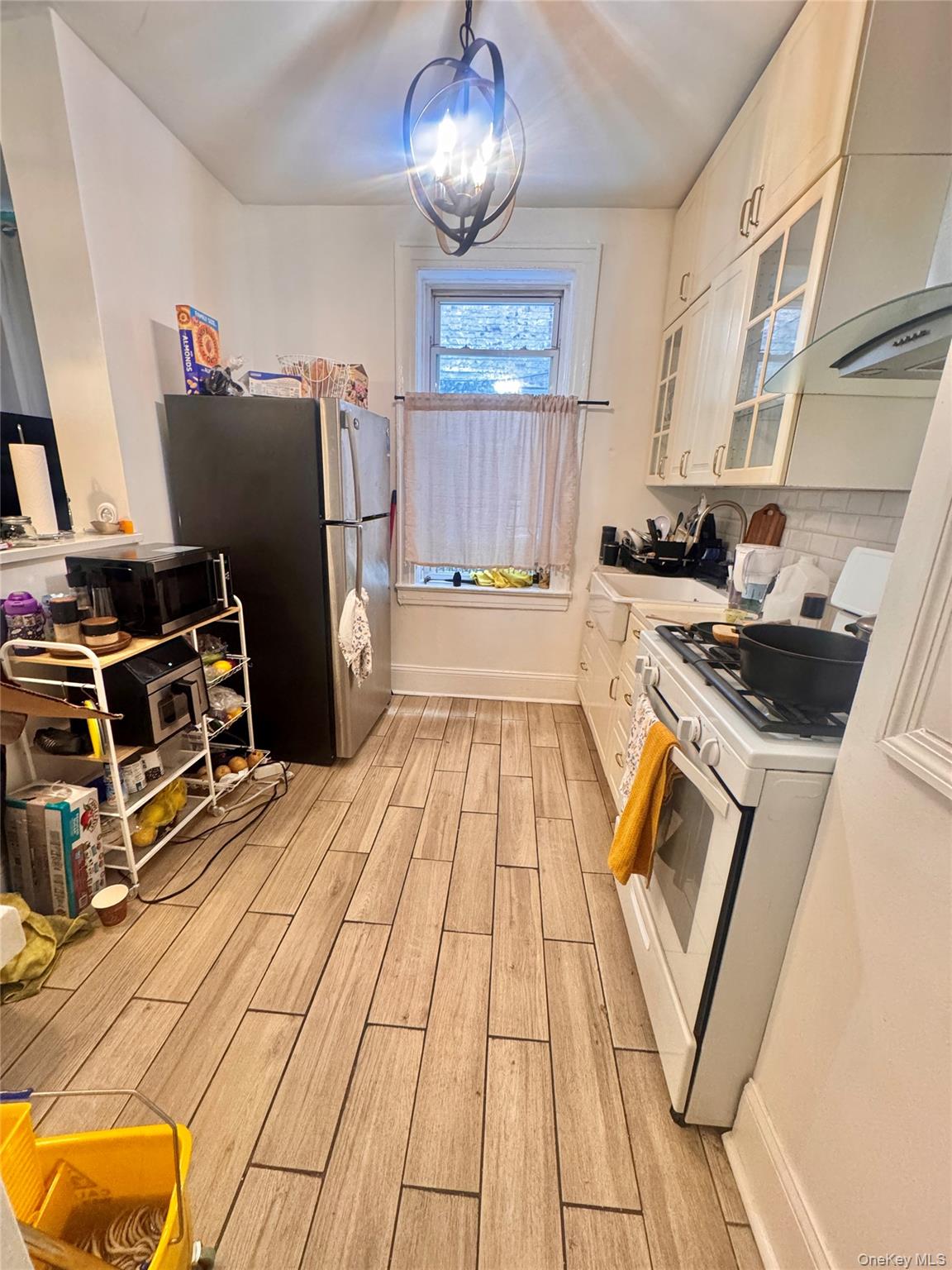 33-54 99th Street Queens, NY 11368 - Photo 36 of 41 a kitchen with stainless steel appliances granite countertop a stove and a refrigerator