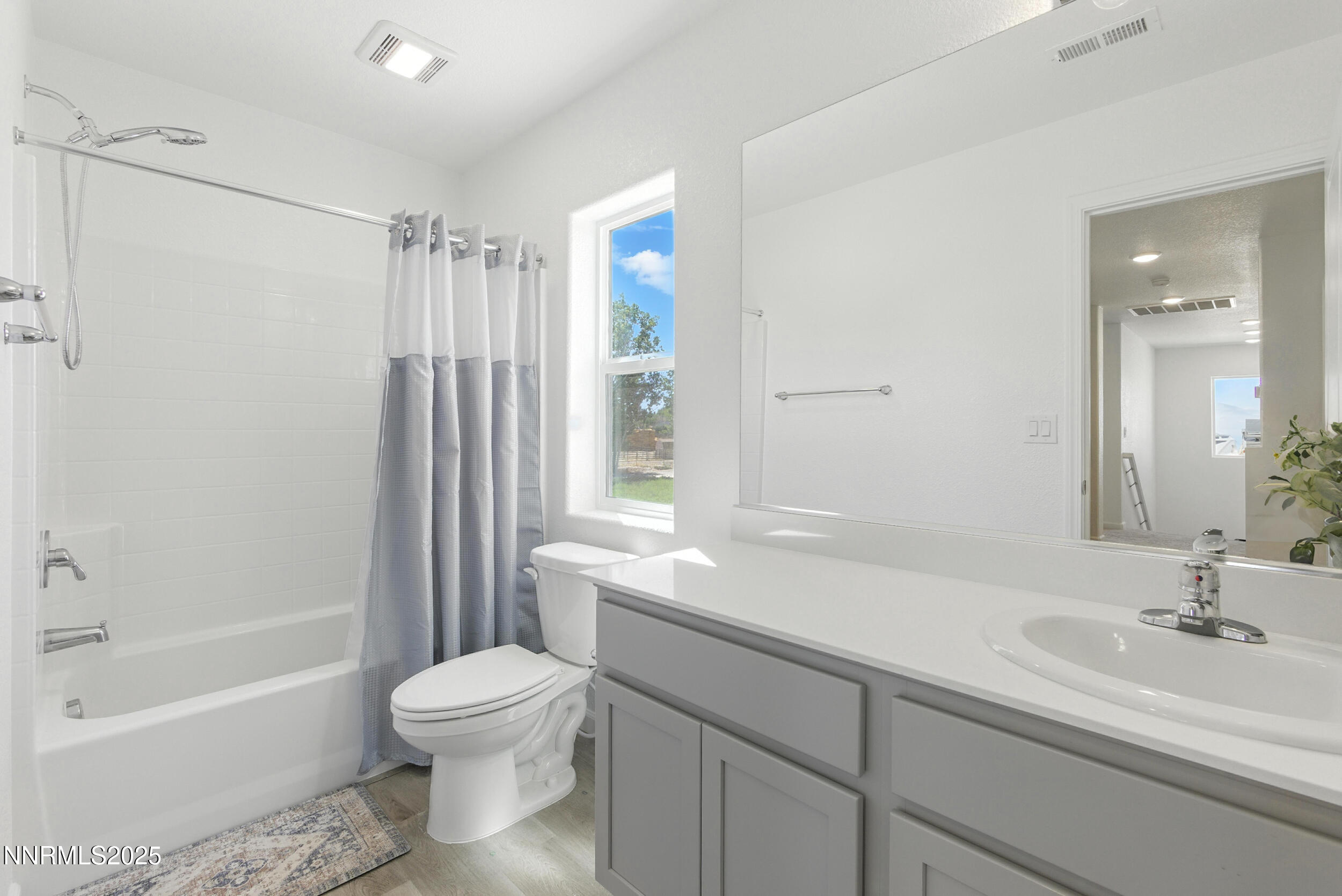 6778 Shell Court Fernley, NV 89408 - Photo 25 of 33 a bathroom with a sink toilet a shower and a mirror