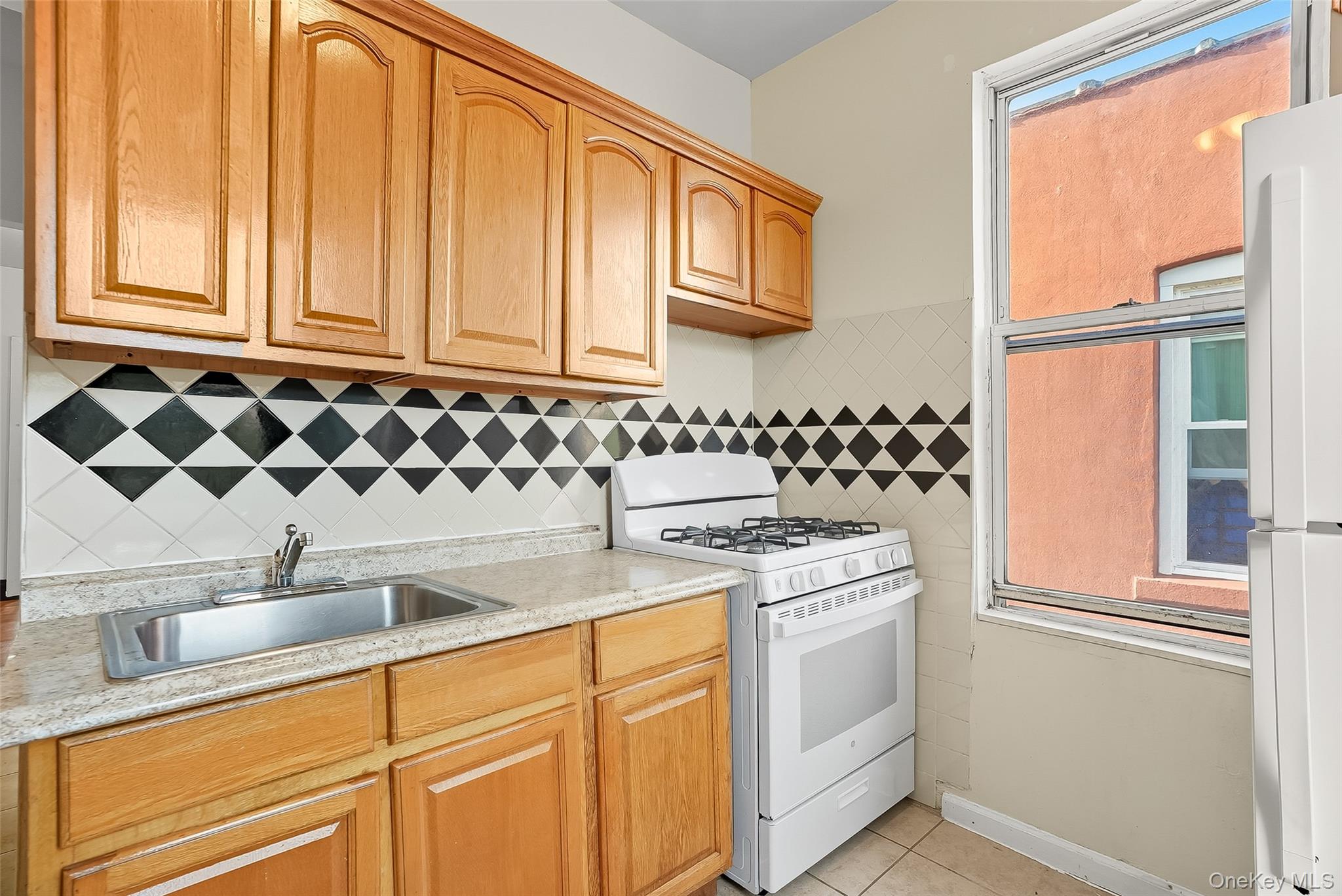 1036 Metcalf Avenue Bronx, NY 10472 - Photo 12 of 26 a kitchen with a sink and cabinets