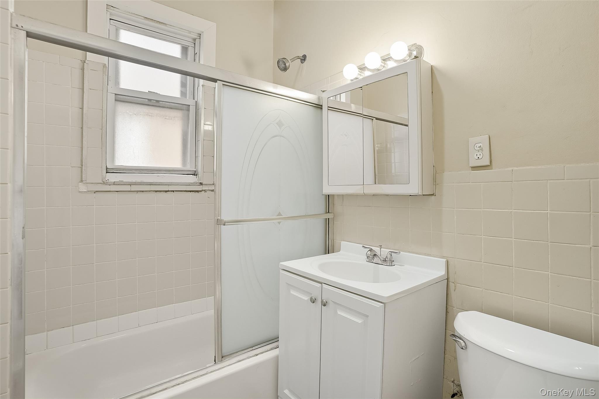 1036 Metcalf Avenue Bronx, NY 10472 - Photo 16 of 26 a bathroom with a sink a toilet and shower
