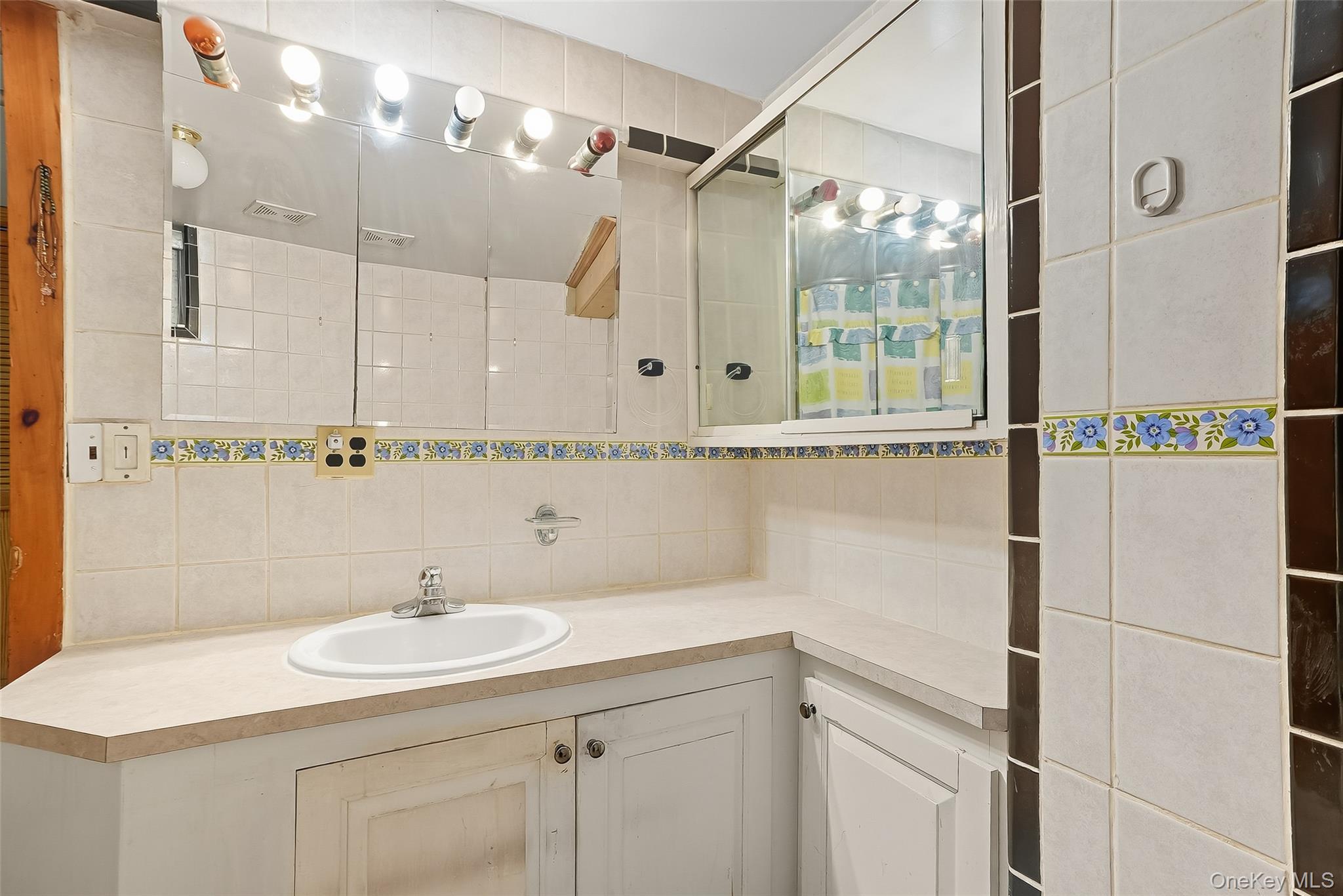 1036 Metcalf Avenue Bronx, NY 10472 - Photo 20 of 26 a bathroom with a sink and a mirror