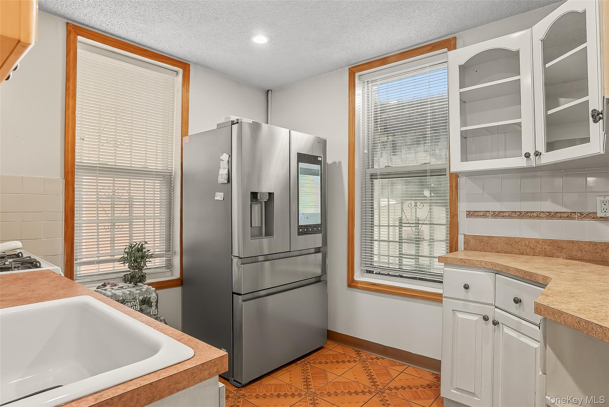 1036 Metcalf Avenue Bronx, NY 10472 - Photo 4 of 26 a kitchen with stainless steel appliances a refrigerator and a sink