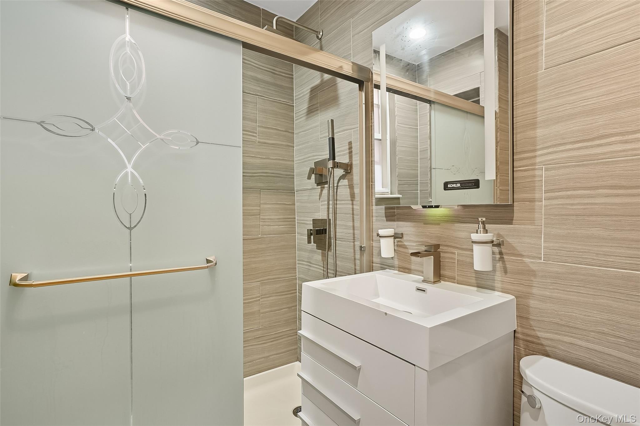 1036 Metcalf Avenue Bronx, NY 10472 - Photo 8 of 26 a bathroom with a sink a mirror and shower