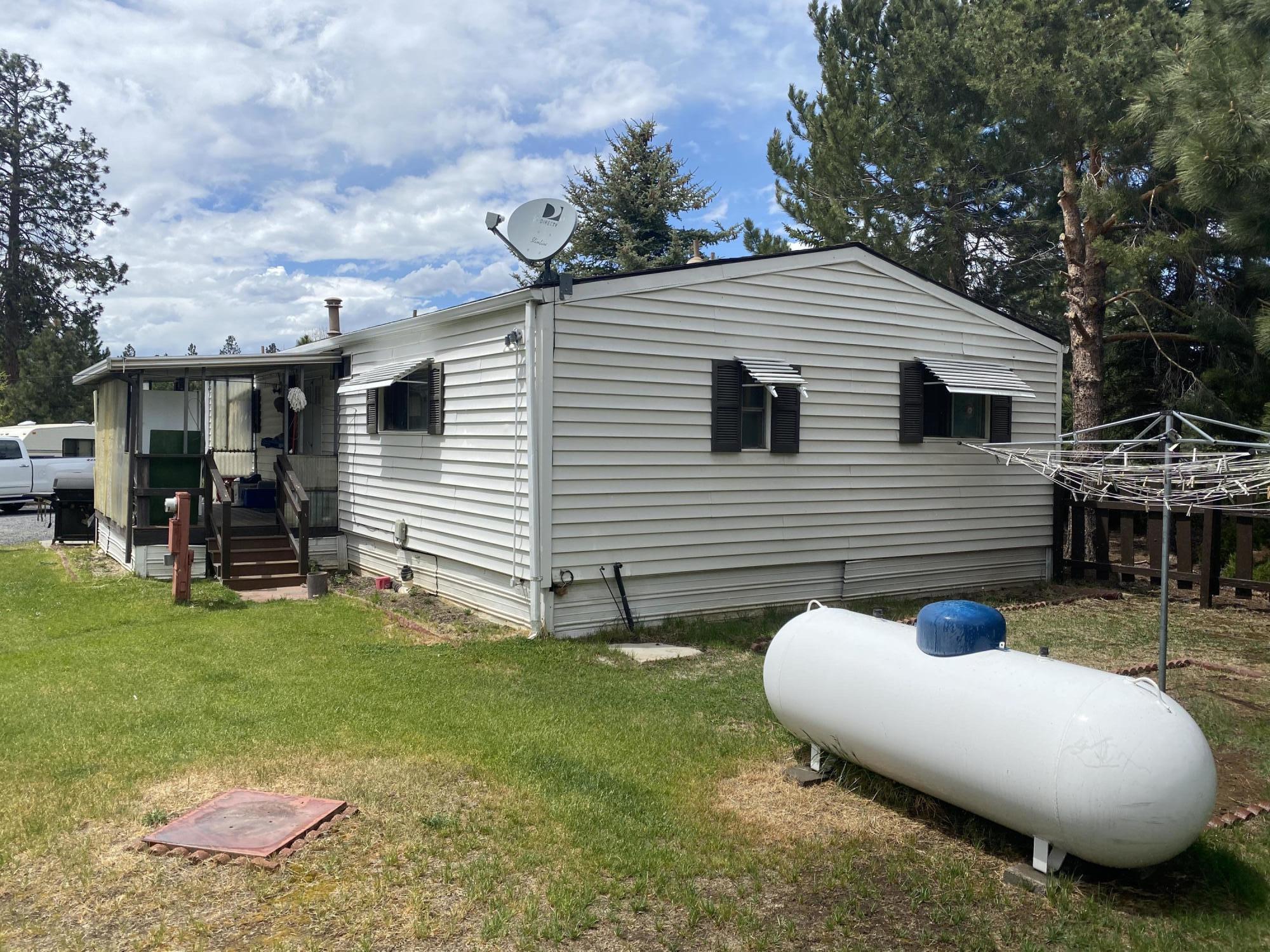 19553 Apache Road Bend, OR 97702 - Photo 10 of 18 a view of a backyard with table and chairs and a fire pit