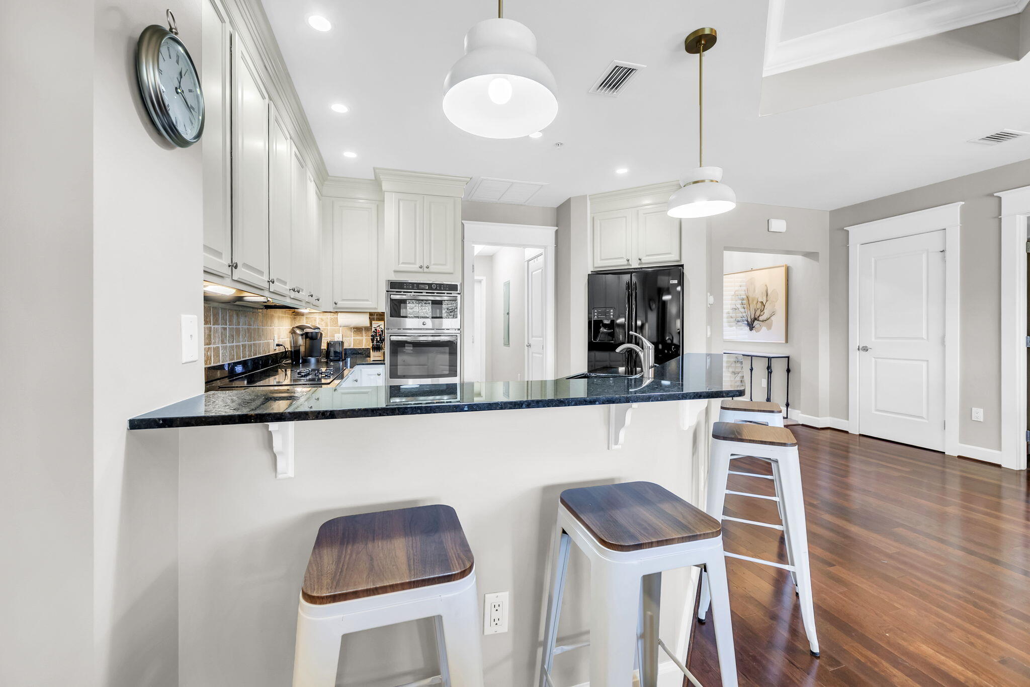 5360 Pine Ridge Lane, Unit 5360 Miramar Beach, FL 32550 - Photo 19 of 44 a kitchen with stainless steel appliances granite countertop wooden cabinets a stove a sink and a chairs