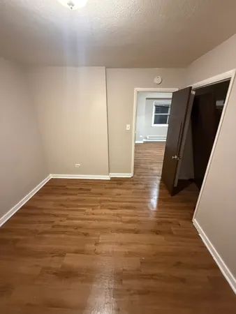 a view of room with wooden floor